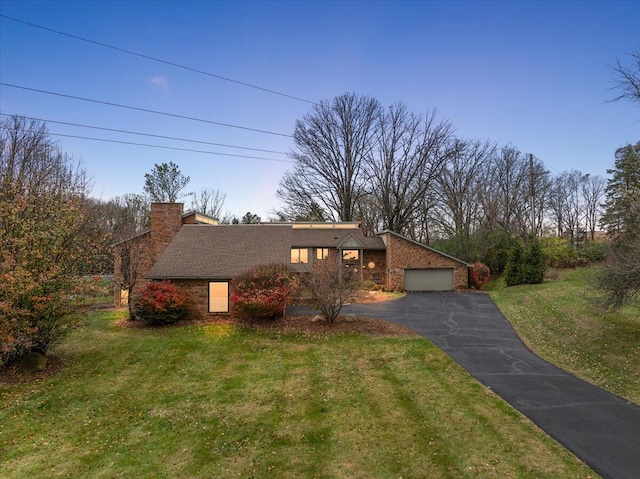 view of front of home featuring a garage and a front lawn