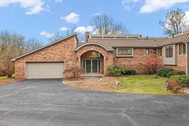 view of front of property with a front yard and a garage