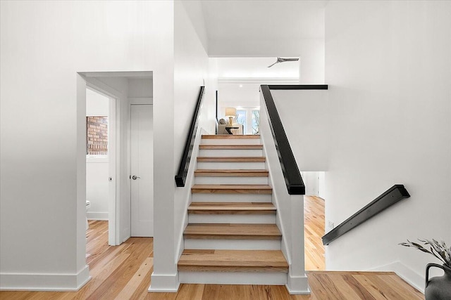 staircase with hardwood / wood-style floors