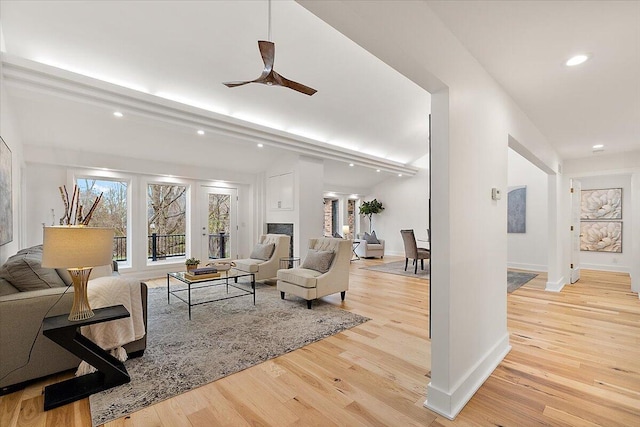 living room featuring ceiling fan and light wood-type flooring