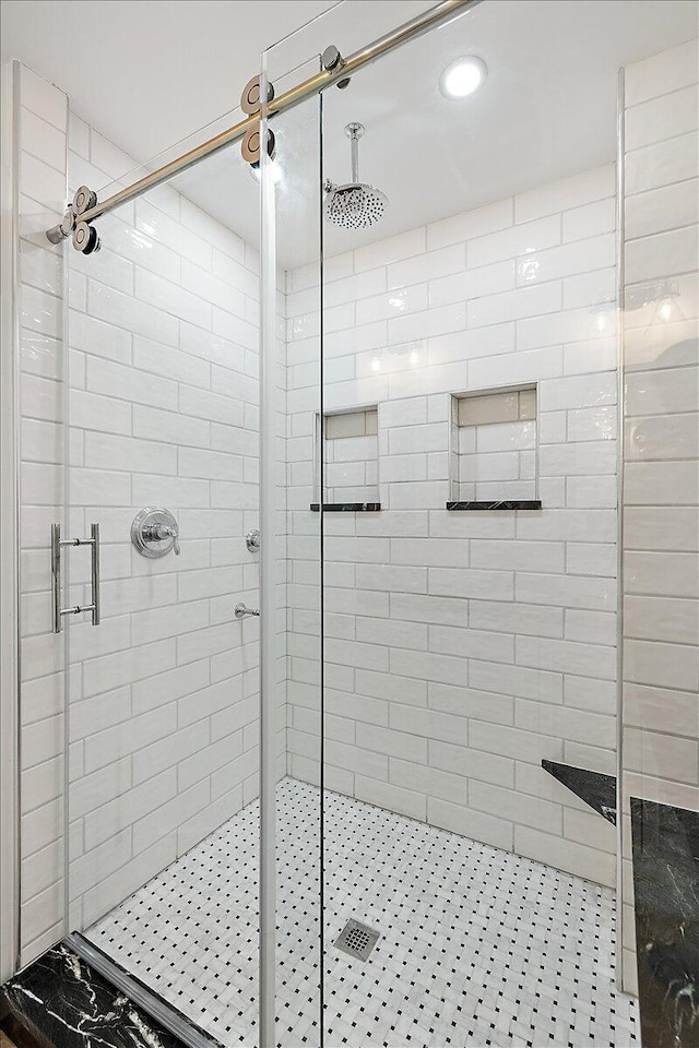 bathroom with a shower with shower door