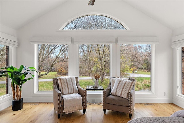 sunroom featuring lofted ceiling