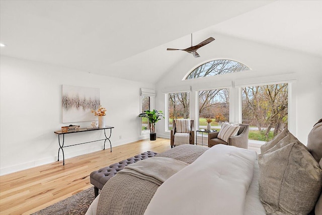 living room featuring ceiling fan, high vaulted ceiling, and hardwood / wood-style flooring