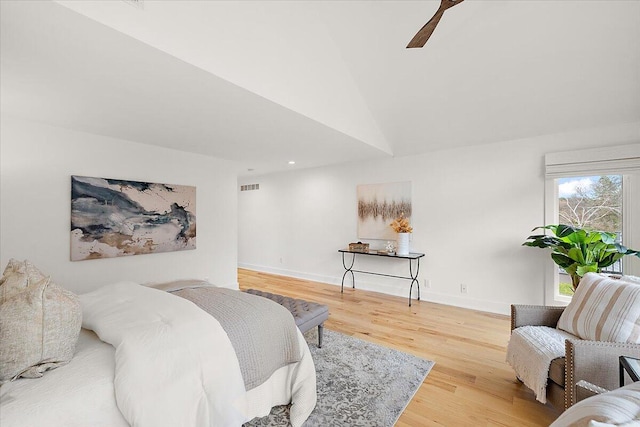 bedroom with ceiling fan, wood-type flooring, and lofted ceiling