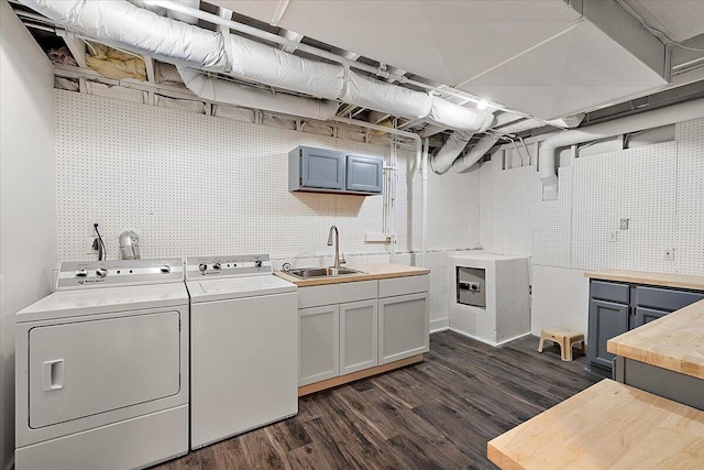 clothes washing area featuring cabinets, separate washer and dryer, dark wood-type flooring, and sink