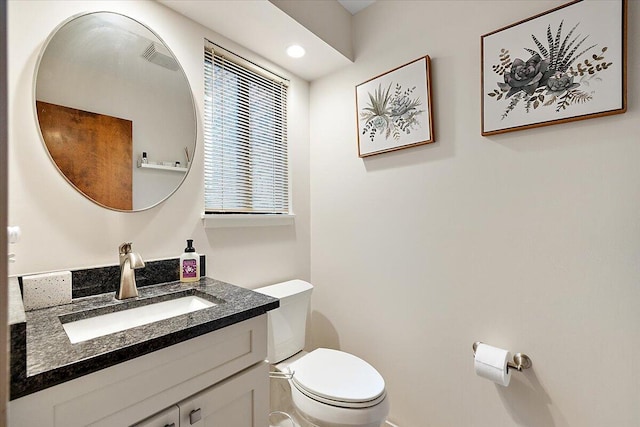 bathroom featuring vanity and toilet