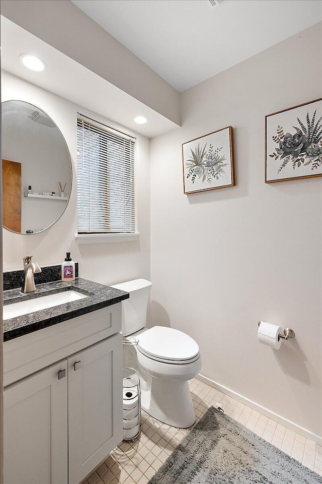 bathroom featuring tile patterned floors, vanity, and toilet