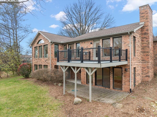 back of house featuring a yard, a patio, and a wooden deck