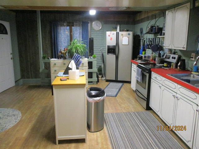 kitchen featuring light hardwood / wood-style floors, sink, white cabinetry, and appliances with stainless steel finishes