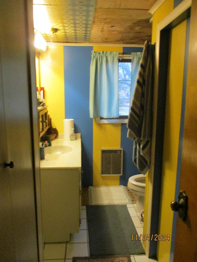 bathroom featuring toilet, vanity, tile patterned flooring, heating unit, and wood ceiling