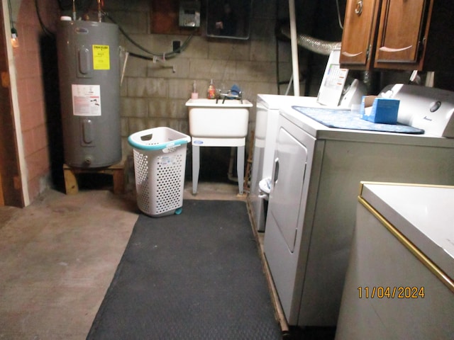 laundry room featuring water heater, cabinets, washer and dryer, and sink