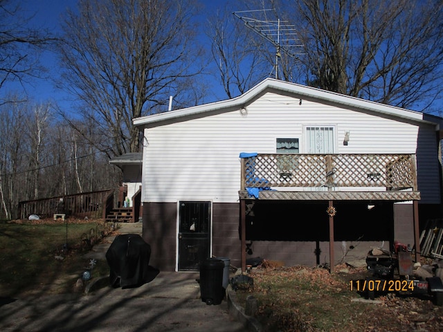 view of property exterior with a wooden deck