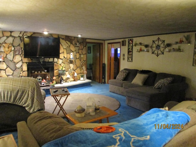 living room with carpet floors and a stone fireplace