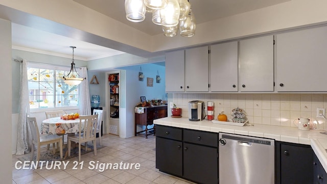 527 Leland St, Flushing, MI 48433 - kitchen featuring dishwasher, a chandelier, decorative backsplash, ornamental molding, and tile countertops