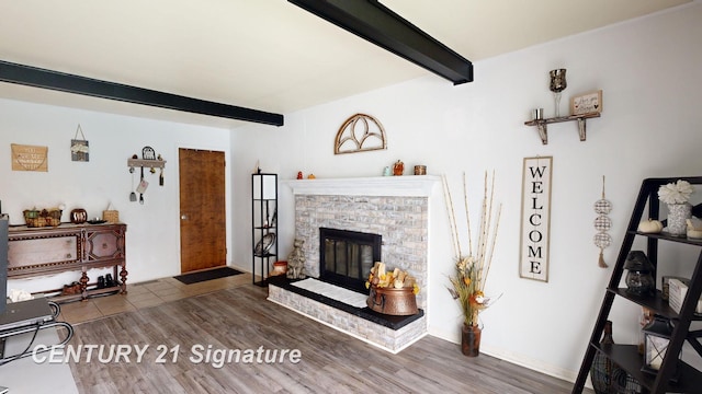 527 Leland St, Flushing, MI 48433 - living room with beamed ceiling, wood finished floors, and a glass covered fireplace