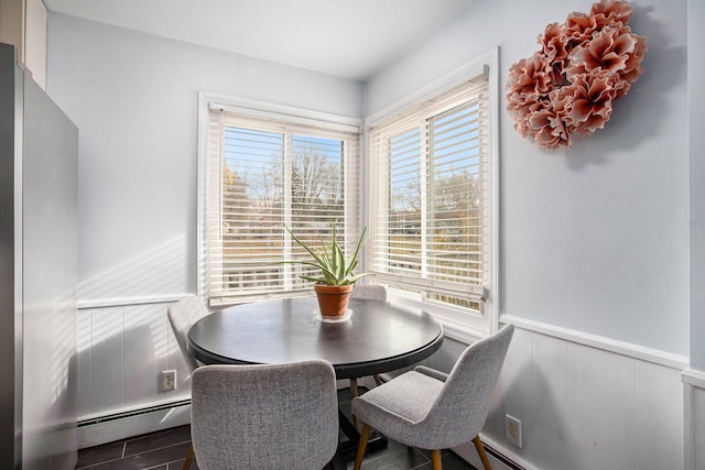 dining room with hardwood / wood-style flooring and baseboard heating