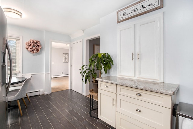 interior space with dark hardwood / wood-style floors and baseboard heating