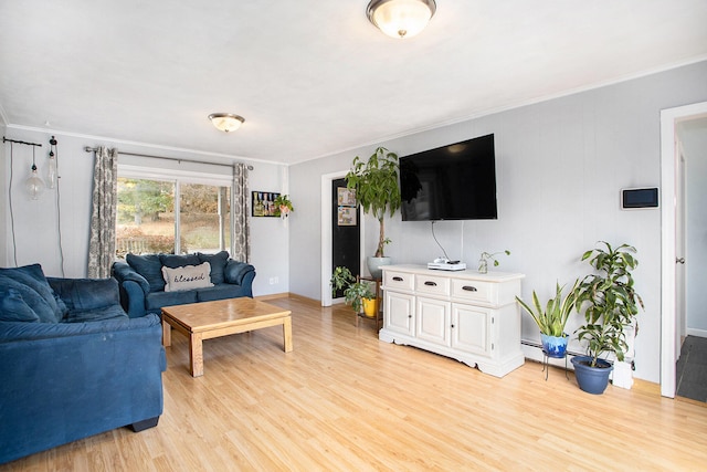 living room with light wood-type flooring and ornamental molding