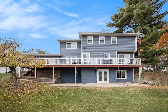 back of house with a lawn, a patio, and a wooden deck