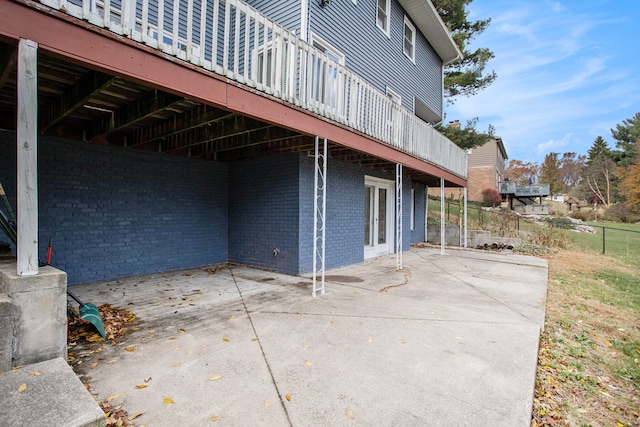 exterior space with a patio area and a wooden deck