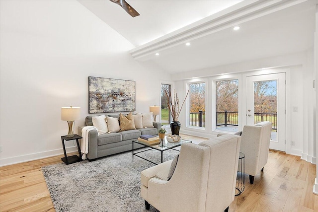 living room with beam ceiling, light wood-type flooring, high vaulted ceiling, and french doors