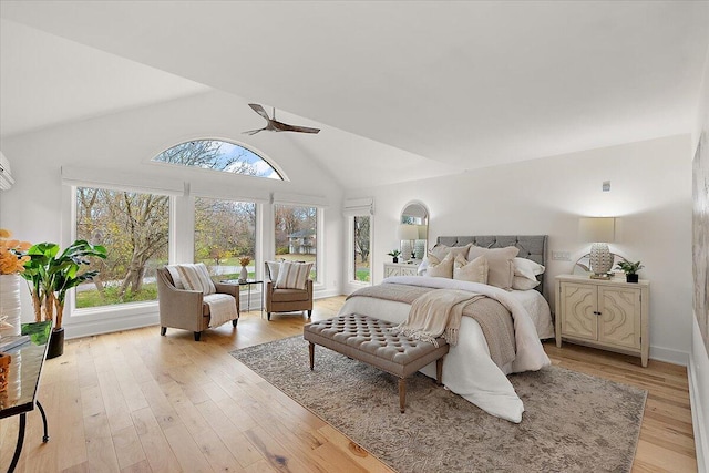 bedroom featuring ceiling fan, light hardwood / wood-style floors, and lofted ceiling