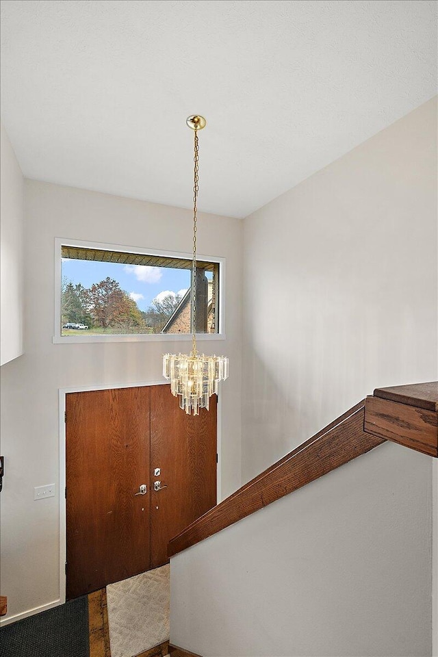 foyer with a chandelier