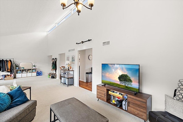 carpeted living room with high vaulted ceiling