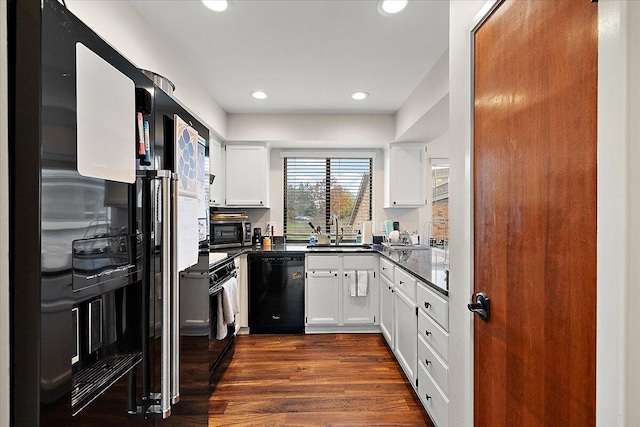 kitchen with black appliances, dark hardwood / wood-style floors, white cabinetry, and sink