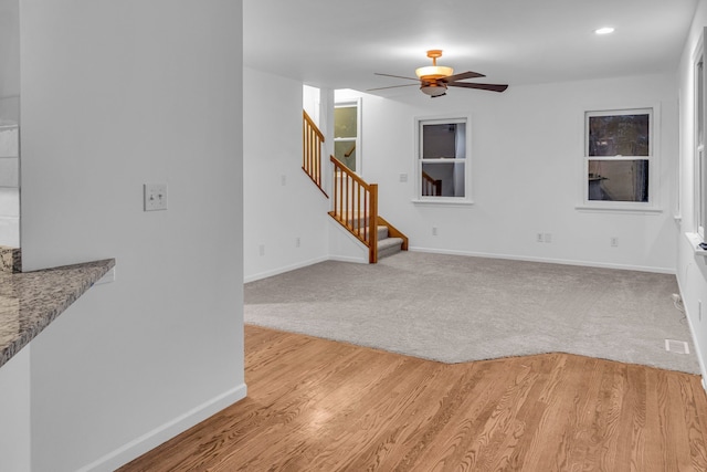 living room featuring ceiling fan and light colored carpet