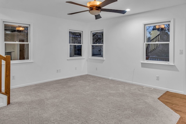 empty room featuring carpet flooring and ceiling fan