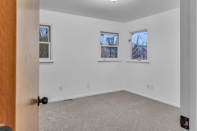 carpeted empty room with a wealth of natural light