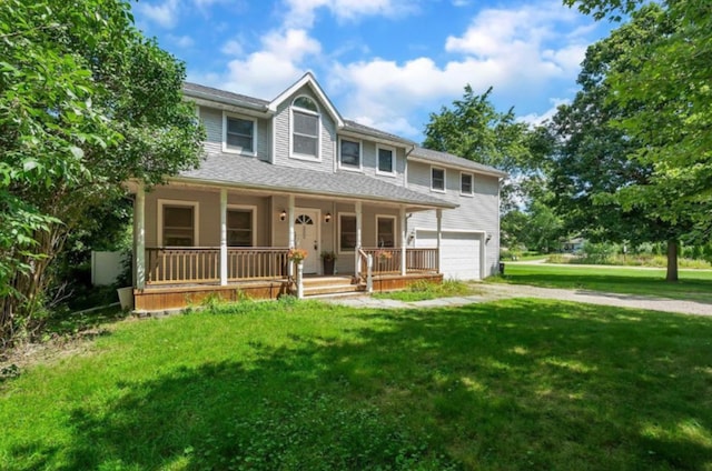 view of front of home with a front yard, a porch, and a garage