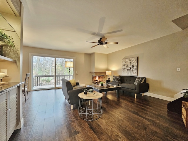 living room with ceiling fan and dark hardwood / wood-style flooring