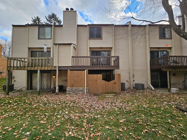 rear view of house featuring central AC unit