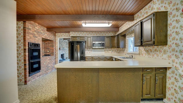 kitchen featuring kitchen peninsula, beam ceiling, sink, and black appliances