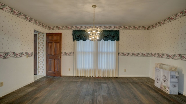 unfurnished dining area featuring dark hardwood / wood-style floors and a notable chandelier