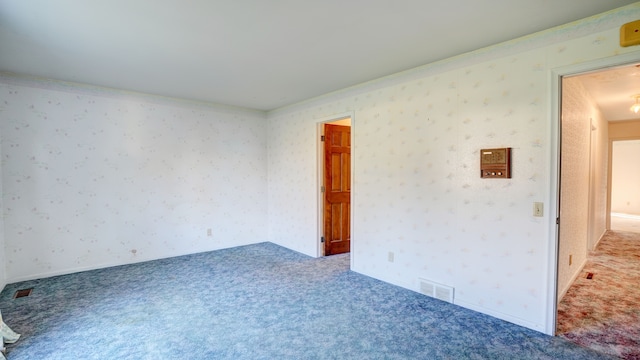 carpeted empty room with crown molding