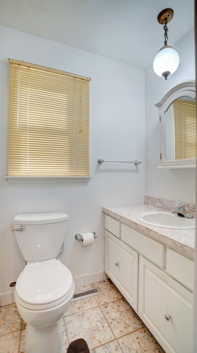 bathroom featuring tile patterned floors, vanity, and toilet