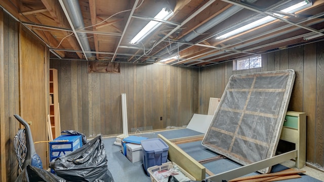 basement featuring wood walls