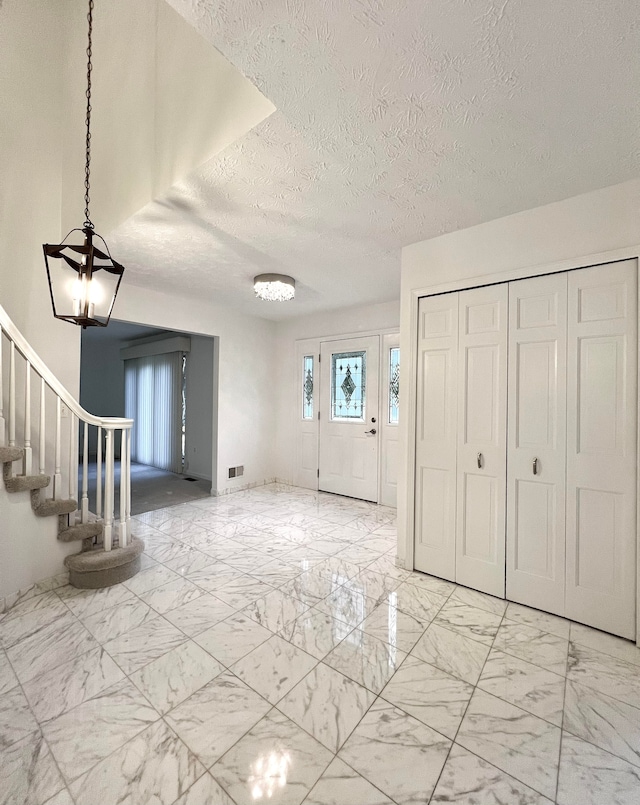 entrance foyer with a textured ceiling