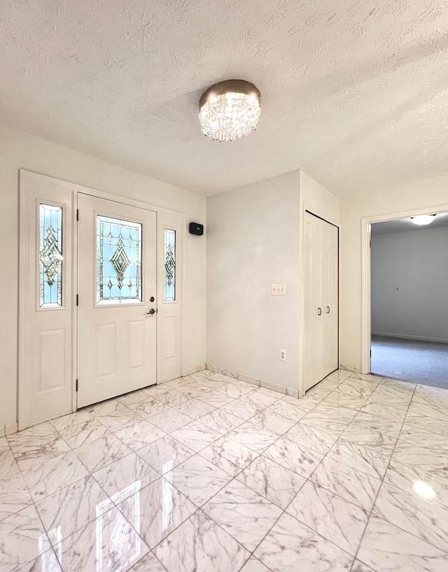 foyer featuring a textured ceiling