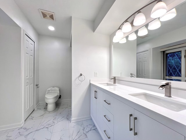 bathroom featuring vanity and toilet