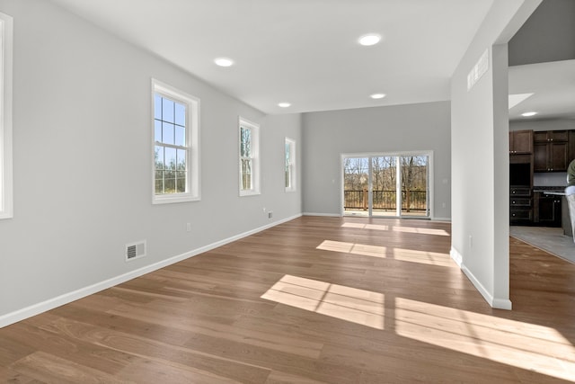 unfurnished living room with light hardwood / wood-style floors