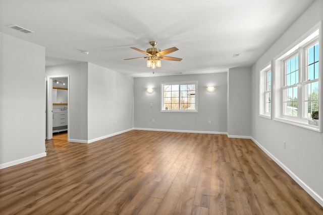 unfurnished room featuring ceiling fan and dark wood-type flooring