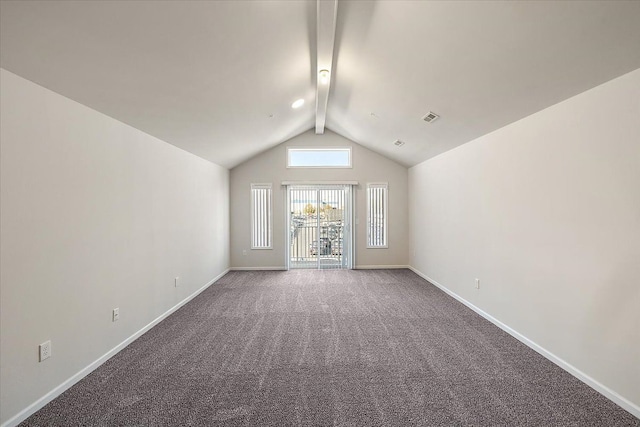 carpeted empty room with vaulted ceiling