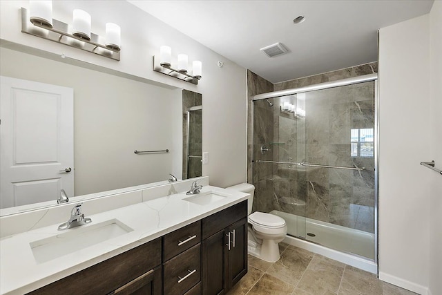 bathroom with vanity, an enclosed shower, and toilet