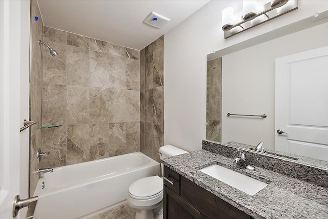 full bathroom with vanity, tiled shower / bath combo, and toilet