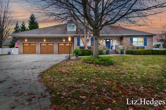 view of front of property featuring a yard and a garage