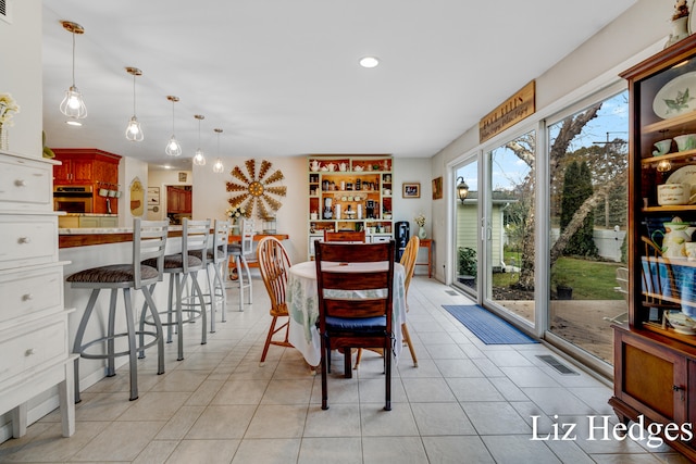 dining area featuring light tile patterned flooring